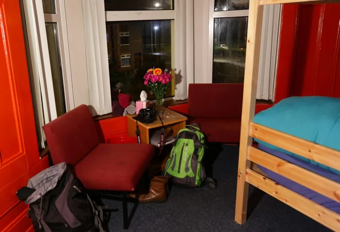 A cosy seating corner by the window, bags packed and ready to go